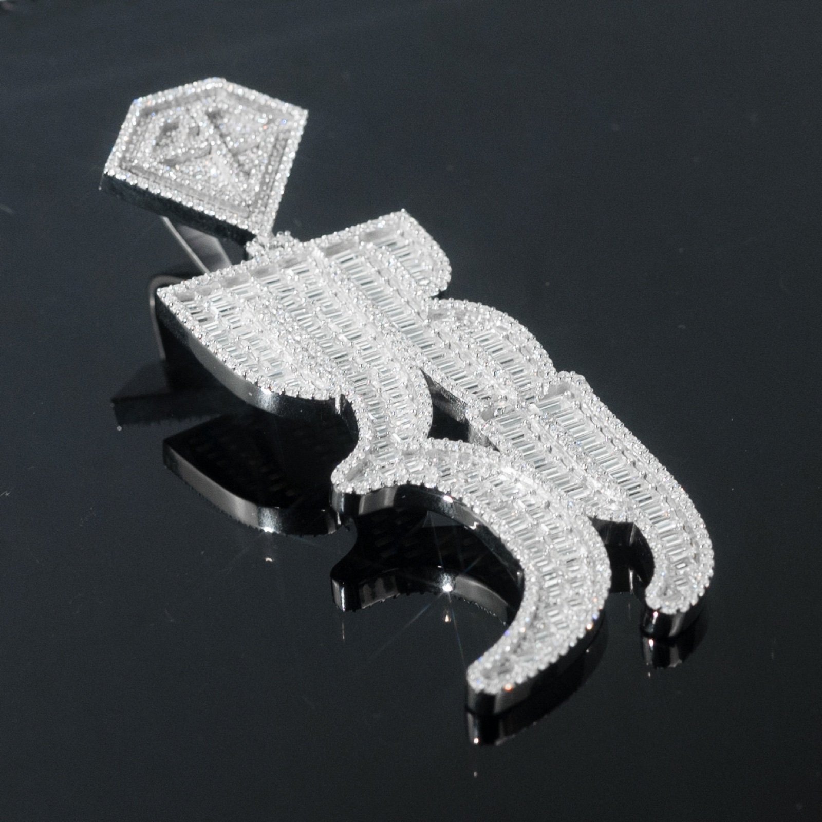 Iced 369 pendant on a dark reflective surface